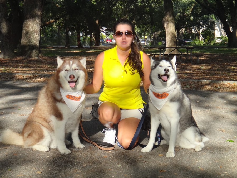 Kat Neuwirth with two Siberian Huskies at a South Broward County park